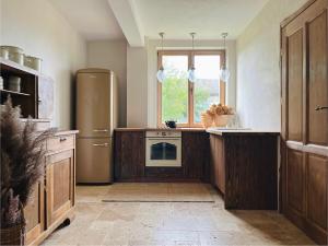 a large kitchen with a refrigerator and a window at Stodoła pod lasem in Kuchary Żydowskie +20 photos