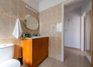 une salle de bain avec toilettes, lavabo et miroir dans l'établissement TelMar Sunrise View 100m from the Sea, à Larnaka 93 autres photos