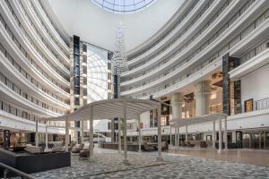 a large building with a chandelier in the middle at Cozy Stay Free Pool Spa & Gym Close to Beach&Mall in Lara