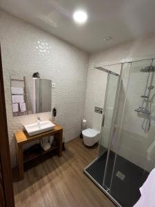 a bathroom with a sink and a shower at Casa da Saboaria in Almeida