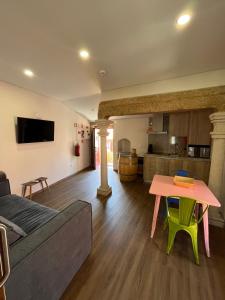 a living room with a couch and a table at Casa da Saboaria in Almeida