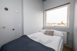 a small bedroom with a bed and a window at LL Properties - TB24 The Signature Loft in Akureyri