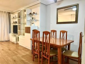 a dining room with a wooden table and chairs at Blue Horizon Campello in El Campello