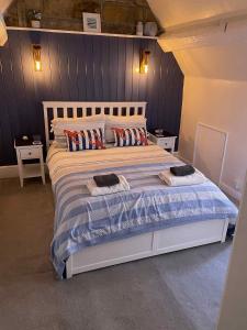 a bedroom with a bed with two towels on it at Dune Cottage in Whitby
