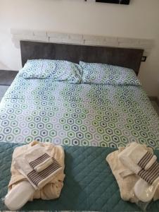 a bed with two towels sitting on top of it at Almes' home in Bosisio Parini