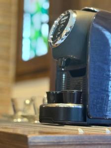 a black coffee maker sitting on a counter at Kappa Rooms Boutique Double Room in Nea Kalikratia