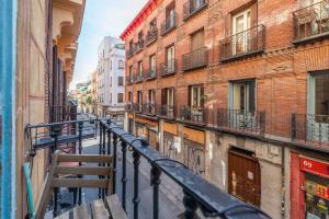 a city street with buildings and a railing at Apartamento con encanto en Malasaña in Madrid