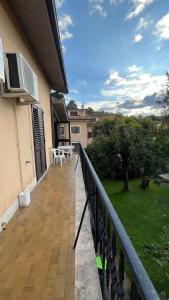 a balcony of a house with a table and chairs at B&B Angelo e Graziella in Monterosi