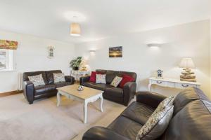 a living room with couches and a coffee table at Host & Stay - Dolphin Dream in Beal +15 photos