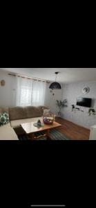 a living room with a couch and a coffee table at Vikendica Amaro in Kiseljak