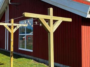 two wooden basketball hoops in front of a red building at 4 star holiday home in Nordborg in Nordborg +35 photos