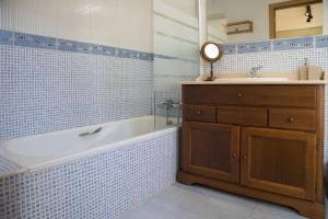 a bathroom with a tub and a sink and a mirror at Villa Playa de Barro in Barro de Llanes +38 photos