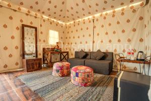 a living room with a couch and a table at Yatra Desert Resort in Jaisalmer