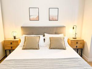 a bedroom with a white bed with two night stands at Suite Ateneo By Silastur in Gijón