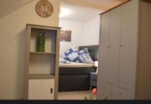 a small room with a bed and a cabinet and a bedroom at Apartment Altstadt 50m vom Bodensee in Meersburg