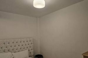 a bedroom with a bed and a light on the ceiling at Studio - Sleeps 2 - Parking - WiFi in Bridgend +3 photos
