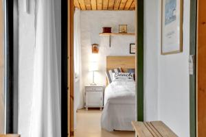 a bedroom with a bed and a table with a lamp at Sdr Strandvej 10, A Central Holiday Oasis in Løkken