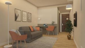 a living room with a couch and orange chairs at Zenit Park Hotel in Rivalta di Torino