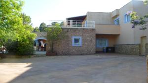 a brick building with a balcony on top of it at Ses Casetes Abajo in San Jose