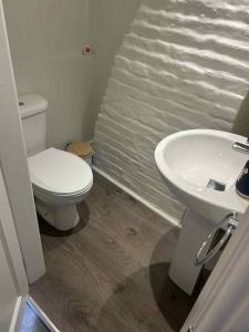 a bathroom with a toilet and a sink at Dune Cottage in Whitby