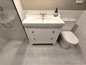 a white bathroom with a sink and a toilet at Playa Sardinero Little Homes 4 in Santander