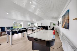 a room with a ping pong table and ping pong balls at Lønstrupvej 46B 10 Pax in Gølstrup