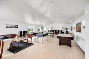 a large white room with tables and chairs at Lønstrupvej 46B 10 Pax in Gølstrup