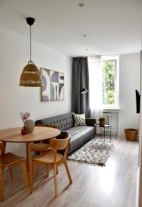 a living room with a couch and a table at Apartament Loft Centrum in Częstochowa
