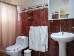 a bathroom with a white toilet and a sink at Vacation home in an exclusive private development in Higuerote +14 photos