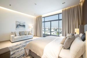 a bedroom with a large bed and a large window at Luxury Villa 8 BR Sea and Mountain View with infinity pool - Al Dana Island Fujairah in Fujairah +31 photos