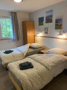 a room with three beds and a window at Argousiers 14, Appartement à Belle Dune in Fort-Mahon-Plage