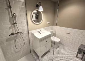 a white bathroom with a sink and a shower at Playa Sardinero Little Homes 6 in Santander