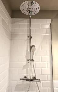 a shower with a light in a bathroom at Playa Sardinero Little Homes 6 in Santander