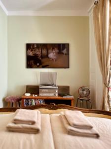 a bedroom with a bed with two folded towels on it at Le bibelot in Saint-Léonard-de-Noblat +7 photos