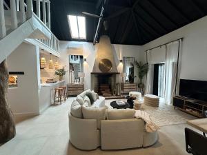 a living room with a couch and a fireplace at Royal Barn Loft in Azambuja