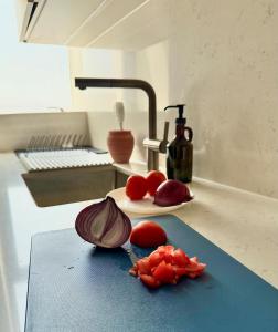 a counter top with some fruit on a cutting board at By The Beach - Prime location in Sarūq