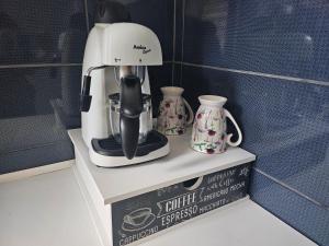 a coffee maker sitting on top of a shelf at Business Apartments 1 in Bydgoszcz