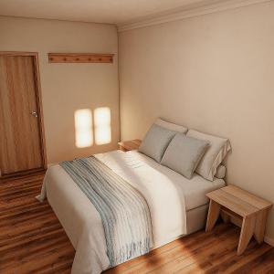 a bedroom with a large bed and a wooden floor at Vila Dorathea in Blumenau
