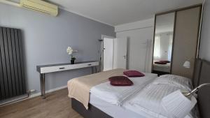 a bedroom with a bed and a desk and a mirror at Apartment Residence Bratislava in Bratislava