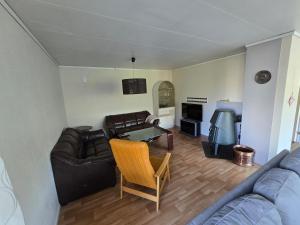 a living room with a couch and a table at Brendefur Panorama in Lii