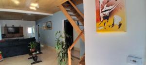 a living room with a staircase and a living room at Quarto do sossego in Morretes
