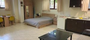 a room with a bed and a kitchen with a table at NEAR AIRPORT 2 STOPS By METRO, STATION METRO"PEANIA-KANTZA" in Leondárion