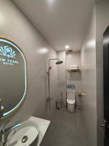 a bathroom with a sink and a mirror and a toilet at New Pearl Hotel HCM in Ho Chi Minh City +36 photos