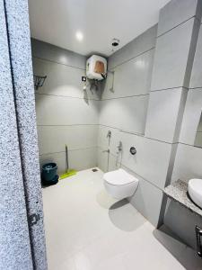 a bathroom with a toilet and a sink at Hotel JMP in Khātu