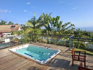 a swimming pool on the deck of a house at Ty Lodge in Les Trois Mares