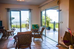 a living room with a table and chairs at Ty Lodge in Les Trois Mares