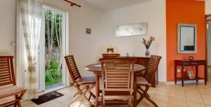 a dining room with a table and chairs at Ty Lodge in Les Trois Mares