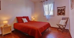 a bedroom with a red bed and a window at Ty Lodge in Les Trois Mares +24 photos