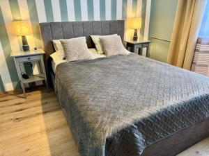 Un dormitorio con una cama grande con dos mesitas de noche. en Apartament Akacja CENTRUM, en Rzeszów