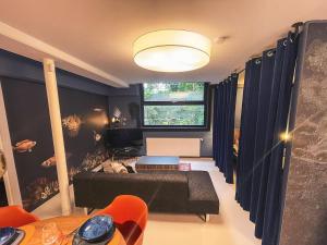 a living room with a couch and a table at Wunderschönes Loft-Apartment im grünen Hamburg in Hamburg +13 photos